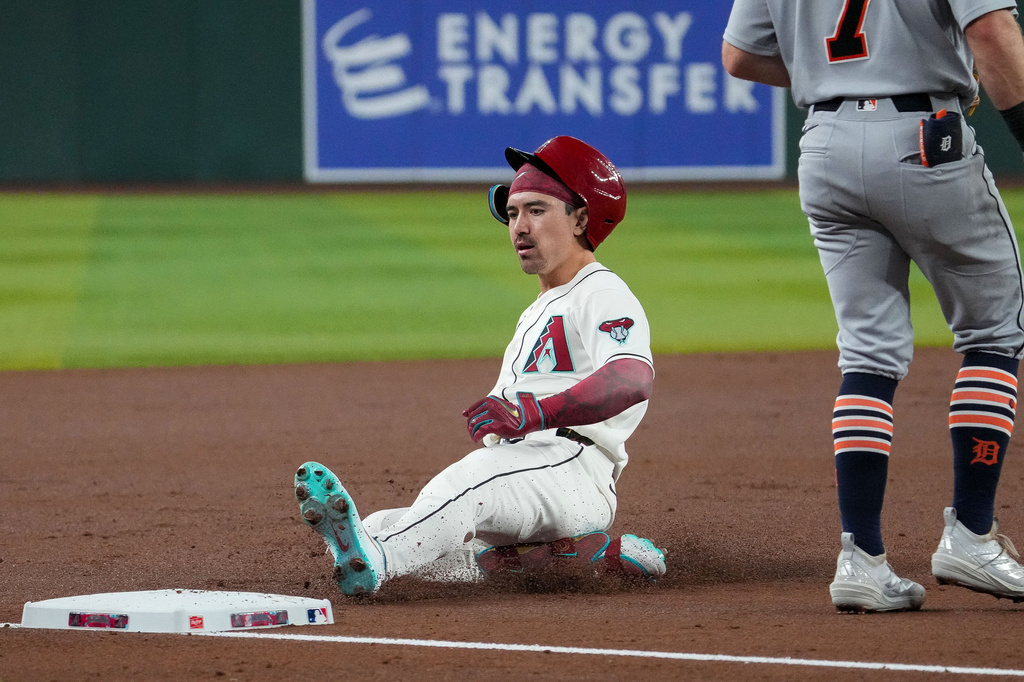 Arizona Diamondbacks' Corbin Carroll (7) slides into third base after hitting a triple against the Detroit Tigers during the first inning of an opening-day baseball game Monday, March 30, 2026, in Phoenix. (AP Photo/Darryl Webb)