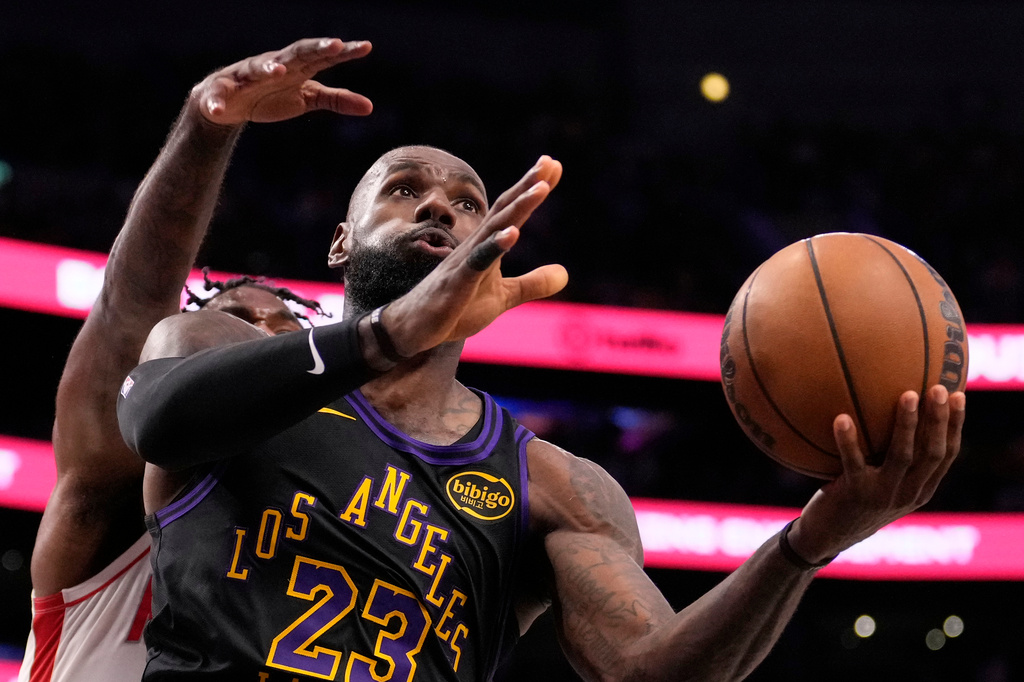 Los Angeles Lakers forward LeBron James, right, shoots as Houston Rockets forward Tari Eason defends during the second half in Game 2 of a first-round NBA playoffs basketball series Tuesday, April 21, 2026, in Los Angeles. (AP Photo/Mark J. Terrill)