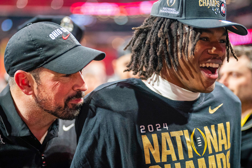 FILE - Ohio State head coach Ryan Day and Ohio State wide receiver Jeremiah Smith (4) celebrate after defeating Notre Dame during the College Football Playoff national championship game Monday, Jan. 20, 2025, in Atlanta. (AP Photo/Jacob Kupferman, File)