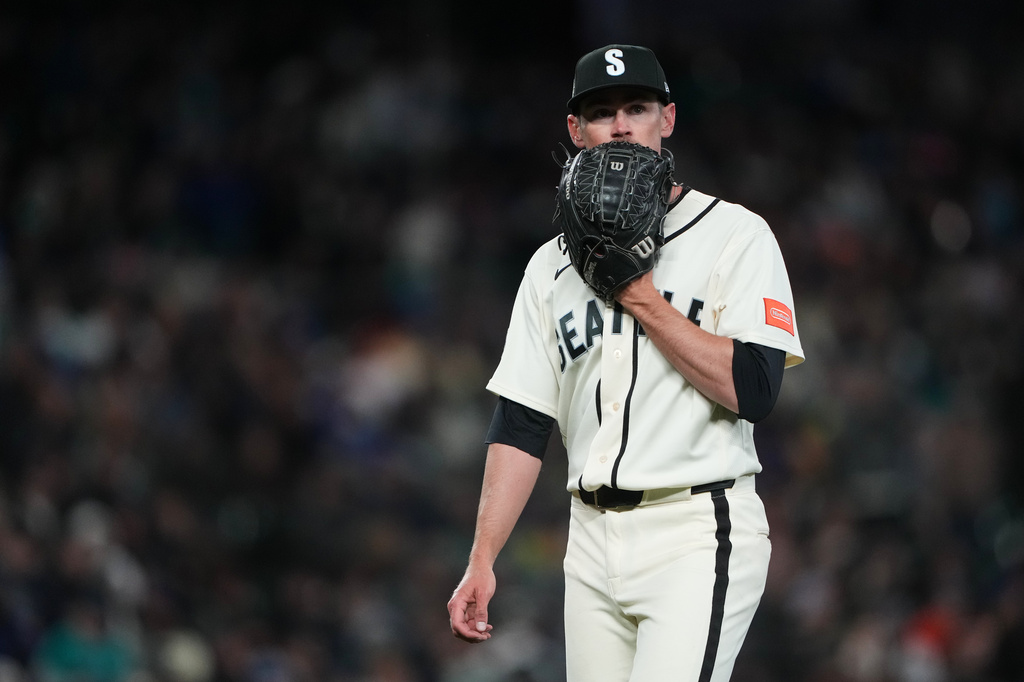 Seattle Mariners starting pitcher Emerson Hancock walks to the dugout after holding the Cleveland Guardians hitless through six innings of a baseball game, Sunday, March 29, 2026, in Seattle. (AP Photo/Lindsey Wasson)