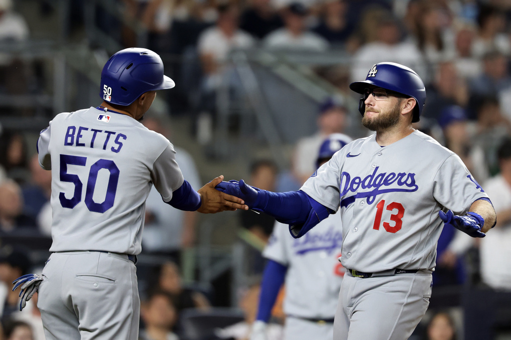 Los Angeles Dodgers' Max Muncy (13) celebrates after his two-run home run with Mookie Betts (50) during the seventh inning of a baseball game against the New York Yankees, Friday, July 17, 2026, in New York. (AP Photo/Adam Hunger)