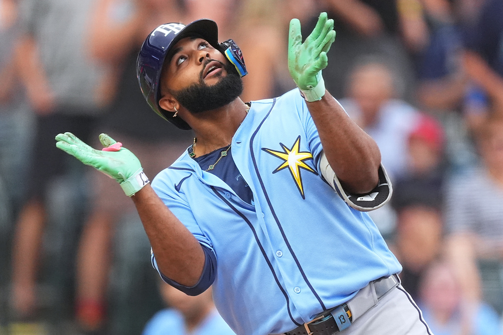 Tampa Bay Rays' Junior Caminero celebrates as he crosses home plate after hitting a two-run home run off Colorado Rockies starting pitcher Michael Lorenzen in the first inning of a baseball game Monday, Aug. 3, 2026, in Denver. (AP Photo/David Zalubowski)