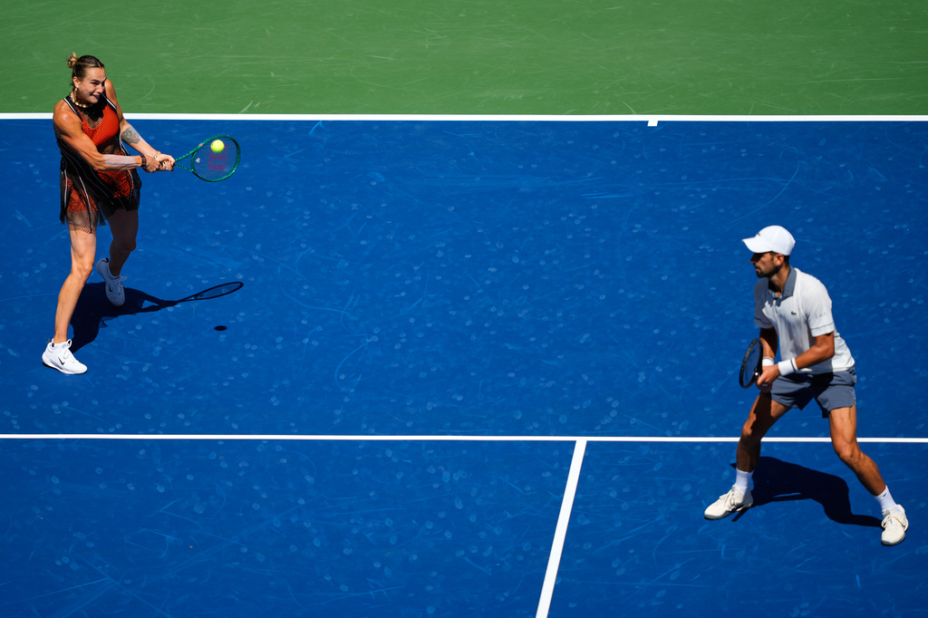 Aryna Sabalenka, of Belarus, and Novak Djokovic, of Serbia, during a mixed doubles match at the U.S. Open tennis championships, Tuesday, Aug. 25, 2026, in New York. (AP Photo/Yuki Iwamura)