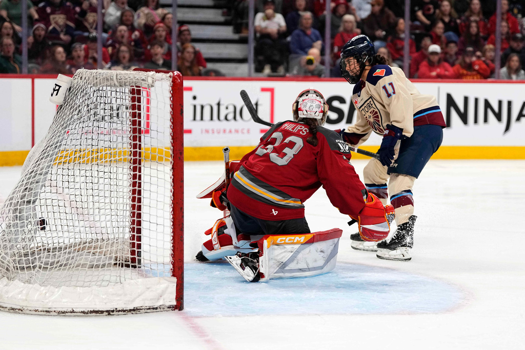 Montreal Victoire's Abby Roque (11) scores against Ottawa Charge goaltender Gwyneth Philips (33) during second-period PWHL hockey game action in Ottawa, Ontario, Friday, April 3, 2026. (Justin Tang/The Canadian Press via AP)