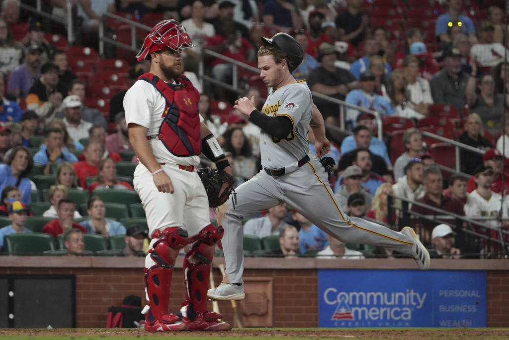 Pittsburgh Pirates' Jack Suwinski, right, scores past St. Louis Cardinals catcher Pedro Pages during the seventh inning of a baseball game Monday, Aug. 25, 2025, in St. Louis. (AP Photo/Jeff Roberson)