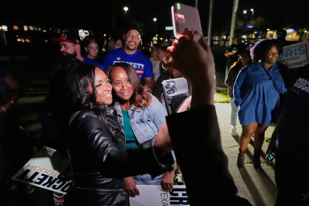 Primary candidate for U.S. Senate Rep. Jasmine Crockett, D-Texas, left, poses for a photo with a supporter at a campaign stop in Dallas, Friday, Feb. 27, 2026. (AP Photo/Tony Gutierrez)