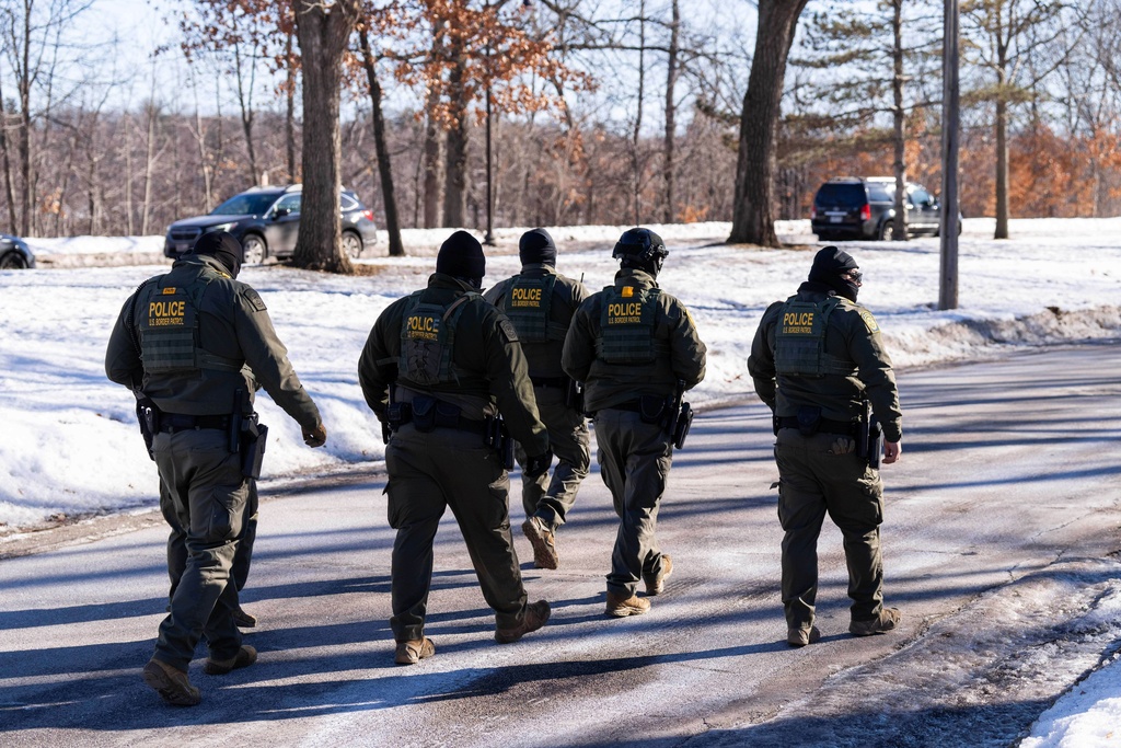 FILE - U.S. Border Patrol officers walk along a street in Minneapolis, Wednesday, Jan. 14, 2026. (AP Photo/Adam Gray,File)