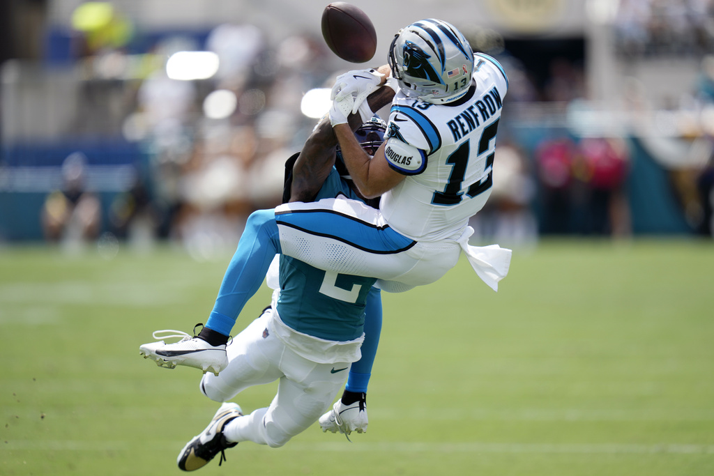 Jacksonville Jaguars cornerback Jourdan Lewis (2) breaks up a pass to Carolina Panthers wide receiver Hunter Renfrow (13) during the first half of an NFL football game, Sunday, Sept. 7, 2025, in Jacksonville, Fla. (AP Photo/John Raoux)