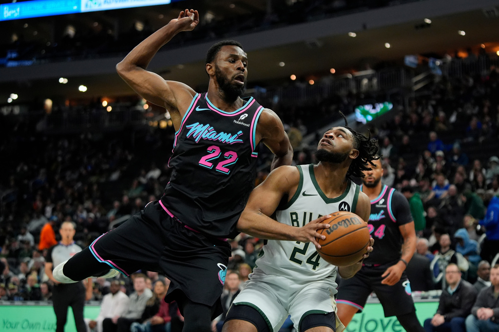 Milwaukee Bucks' Cam Thomas (24) looks to shoot past Miami Heat's Andrew Wiggins during the first half of an NBA basketball game Tuesday, Feb. 24, 2026, in Milwaukee. (AP Photo/Aaron Gash)