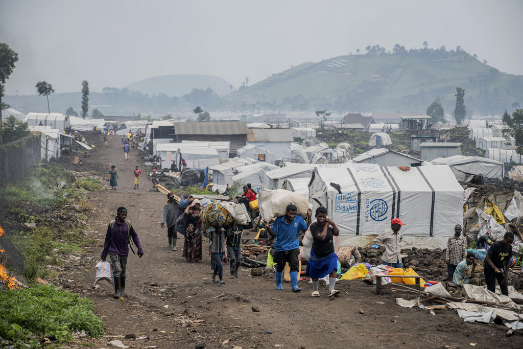 FILE - People who were displaced by the fighting between M23 rebels and government soldiers leave their camp following an instruction by M23 rebels in Goma, Democratic Republic of the Congo, Feb. 11, 2025. (AP Photo/Moses Sawasawa, File)