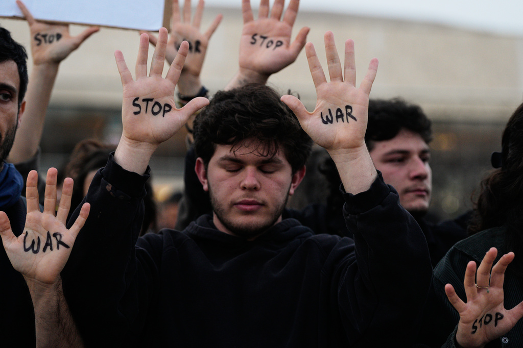 People raise their hands during a protest calling for an end to the war in Tel Aviv, Israel, Saturday, April 4, 2026. (AP Photo/Maya Levin)