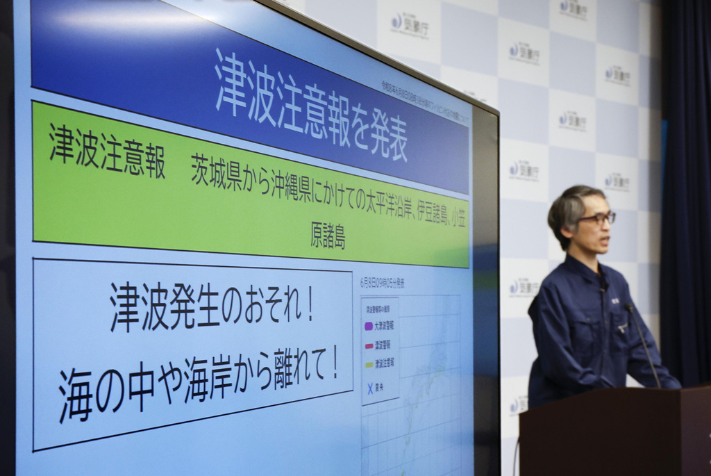 An official of the Japan Meteorological Agency speaks near a monitor showing a tsunami advisory during a news conference at the agency in Tokyo, Monday, June 8, 2026, following a powerful earthquake in Philippines. (Miyuki Saito/Kyodo News via AP)