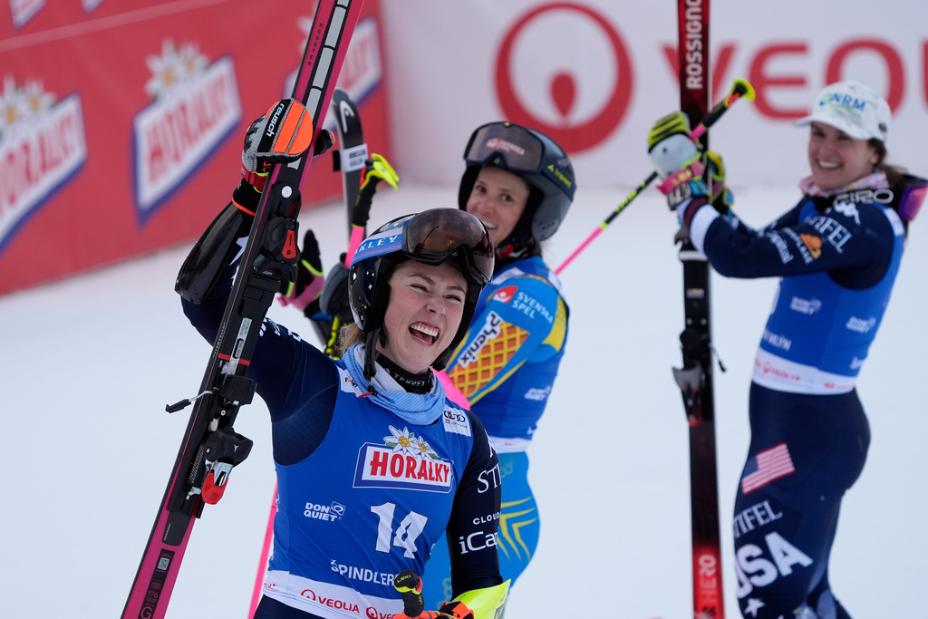 From left, United States' Mikaela Shiffrin, Sweden's Sara Hector and United States' Paula Moltzan at finish line during a women¥s alpine ski, World Cup giant slalom, in Spindleruv Mlyn, Czech Republic, Saturday, Jan. 24, 2026. (AP Photo/Giovanni Auletta)