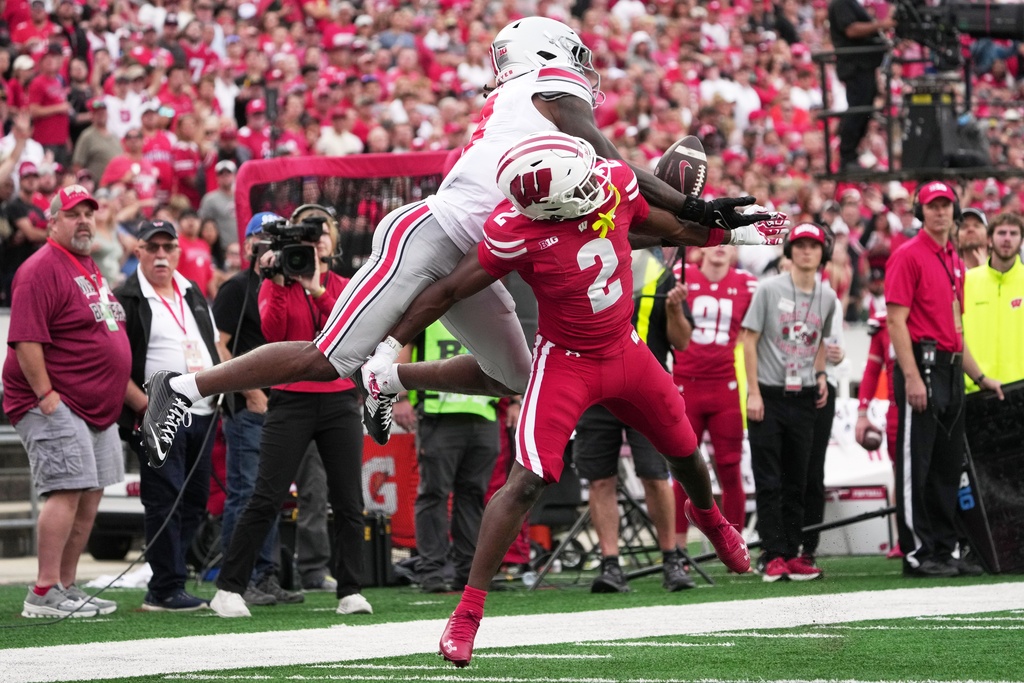 Wisconsin's Ricardo Hallman breaks up a pass intended for Ohio State's Jeremiah Smith during the second half of an NCAA college football game Saturday, Oct. 18, 2025, in Madison, Wis. (AP Photo/Morry Gash)