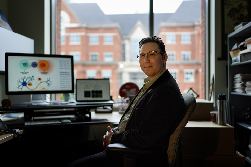 Biomedical engineer Jordan Green sits for a photo in his office at Johns Hopkins University, Tuesday, May 13, 2025, in Baltimore, Md., where his team is crafting a way for the immune system to reprogram itself with the help of instructions delivered by messenger RNA, or mRNA, the genetic code used in COVID-19 vaccines. (AP Photo/David Goldman)