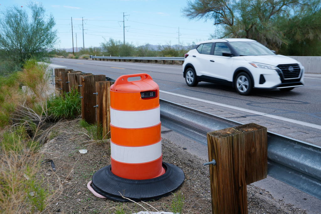 FILE - A license plate reader used by U.S. Border Patrol is hidden in a traffic cone while capturing passing vehicles on AZ Highway 85, Oct. 21, 2025, in Gila Bend, Ariz. (AP Photo/Ross D. Franklin, File)