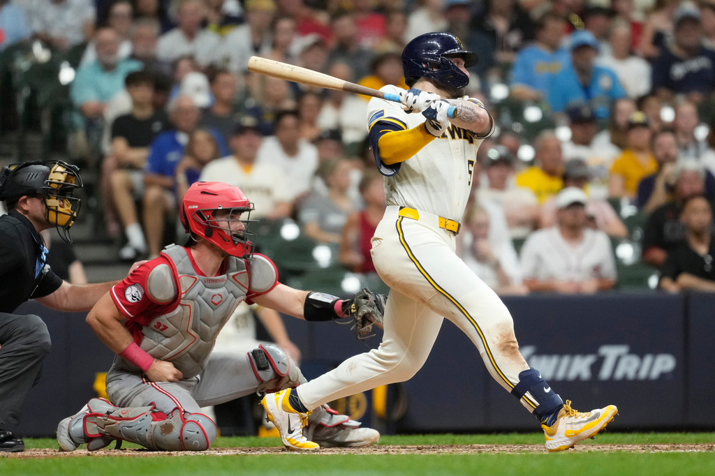 Milwaukee Brewers' Garrett Mitchell hits an RBI triple during the seventh inning of a baseball game against the Cincinnati Reds, Wednesday, July 1, 2026, in Milwaukee. (AP Photo/Aaron Gash)