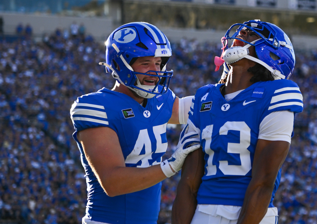 BYU wide receiver Jojo Phillips (13) celebrates a touchdown with teammate Keayen Nead, left, in the first half during an NCAA college football game against Utah Tech Saturday, Sept. 5, 2026 in Provo, Utah. (AP Photo/Alex Goodlett)