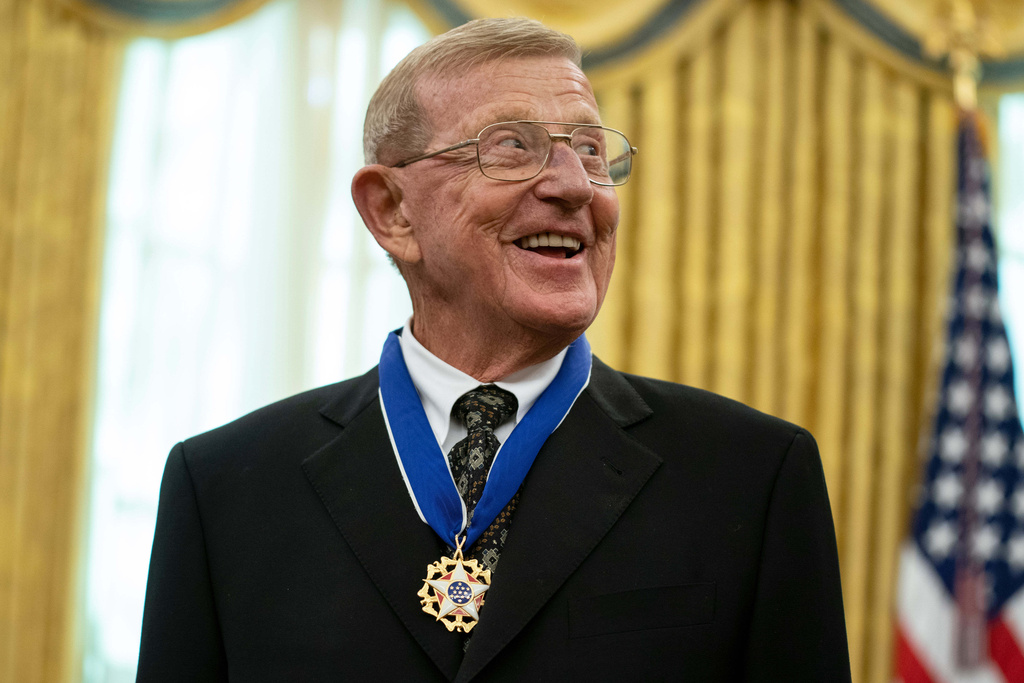 FILE - Former football coach Lou Holtz smiles after receiving the Presidential Medal of Freedom from President Donald Trump, Thursday, Dec. 3, 2020, in the Oval Office of the White House in Washington. (AP Photo/Evan Vucci, File)