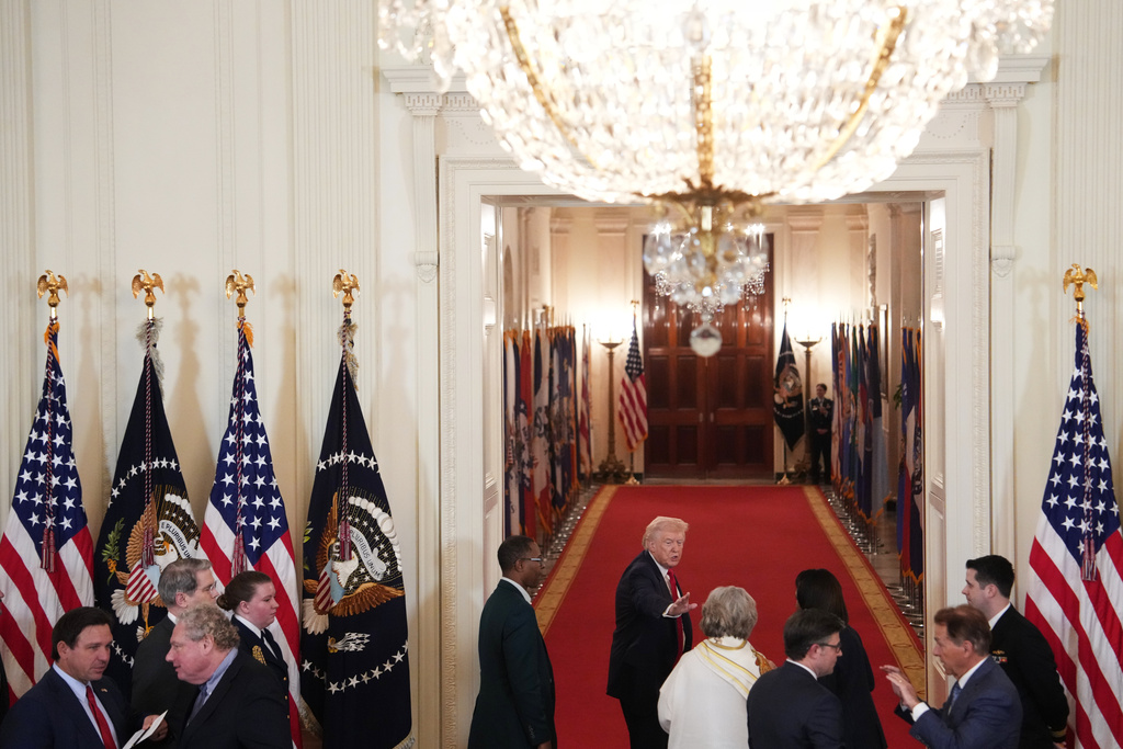 President Donald Trump waves goodbye as he leaves a roundtable discussion on college sports in the East Room of the White House, Friday, March 6, 2026, in Washington. (AP Photo/Julia Demaree Nikhinson)