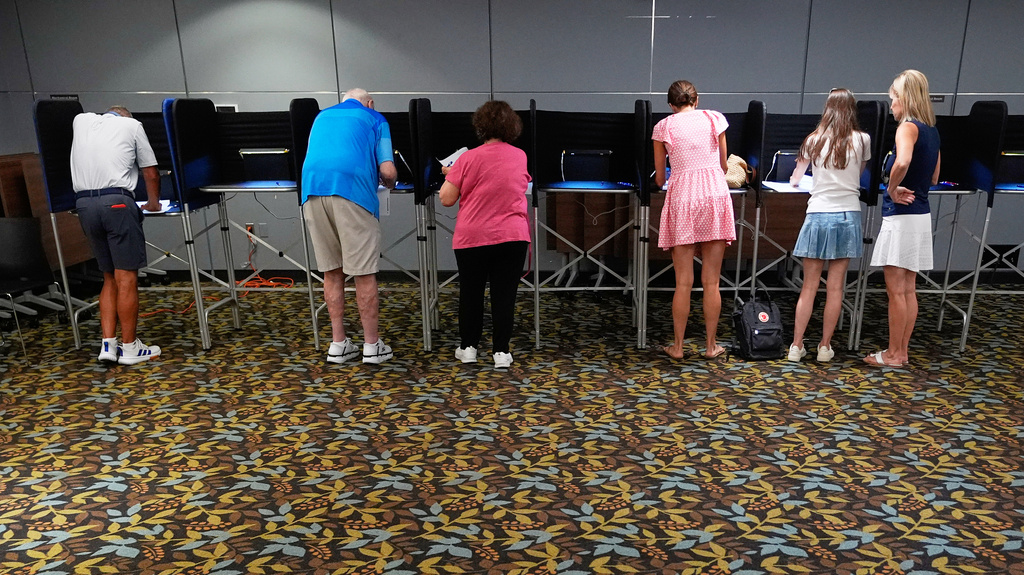 Voters fill out their ballots on primary Election Day at the Baldwin Public Library, Tuesday, Aug. 4, 2026, in Birmingham, Mich. (AP Photo/Paul Sancya)