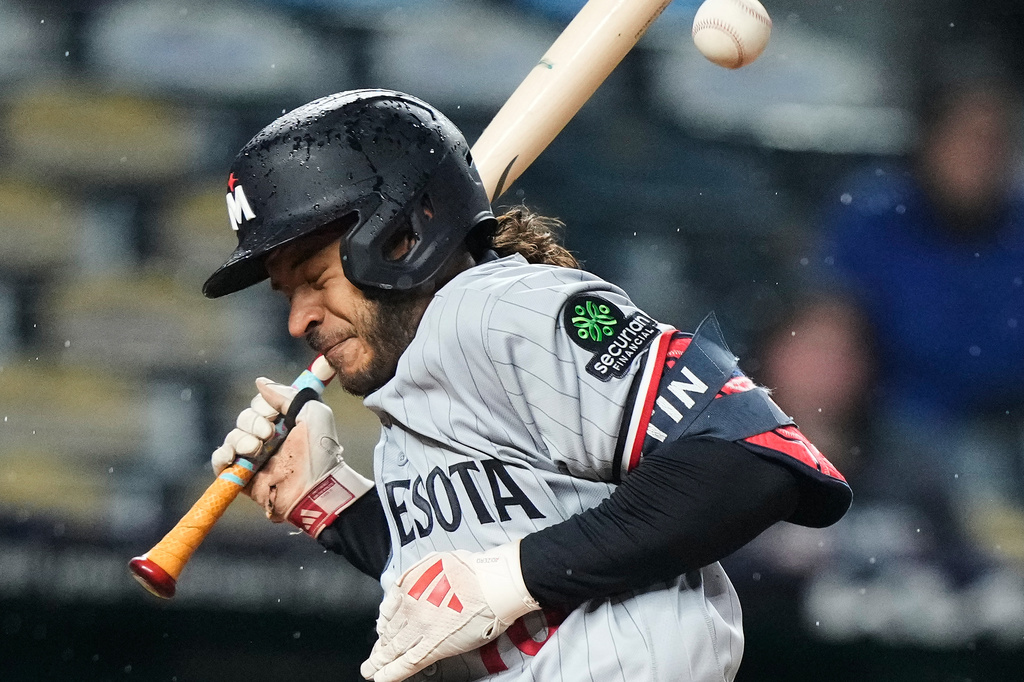 Minnesota Twins' Austin Martin reacts after being hit by a pitch thrown by Kansas City Royals relief pitcher Alex Lange to score a run during the eighth inning of a baseball game Wednesday, April 1, 2026, in Kansas City, Mo. (AP Photo/Charlie Riedel)