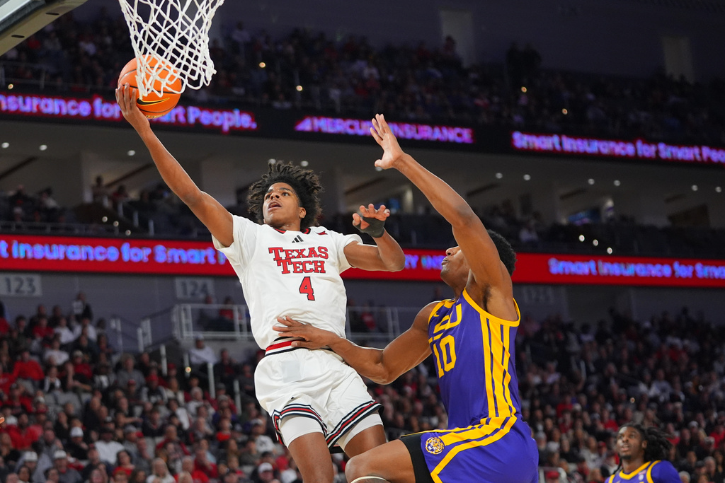 Texas Tech guard Christian Anderson (4) goes up to score against LSU forward Marquel Sutton (10) during the first half of an NCAA college basketball game Sunday, Dec. 7, 2025, in Fort Worth, Texas. (AP Photo/LM Otero)
