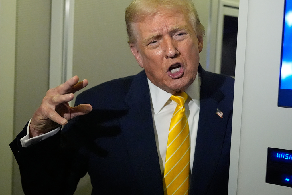 President Donald Trump speaks to reporters on Air Force One on his way to his Mar-a-Lago estate in Palm Beach, Fla., Friday, Nov. 14, 2025. (AP Photo/Manuel Balce Ceneta)