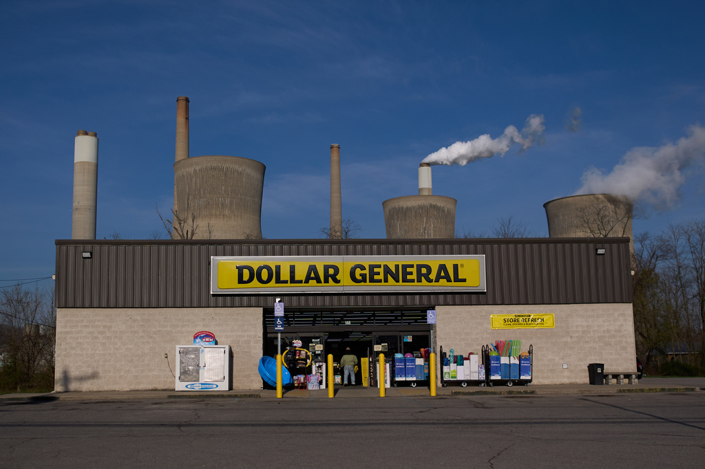 American Electric Power's John Amos coal-fired plant in Winfield, W.Va., stands behind a Dollar General store, Sunday, March 22, 2026, in Poca, W.Va. (AP Photo/Carolyn Kaster)