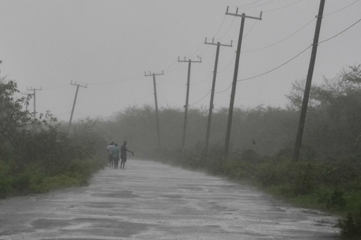 People walk along a road during the passing of Hurricane Melissa in Rocky Point, Jamaica, Tuesday, Oct. 28, 2025. (AP Photo/Matias Delacroix) People walk along a road during the passing of Hurricane Melissa in Rocky Point, Jamaica, Tuesday, Oct. 28, 2025. (AP Photo/Matias Delacroix)