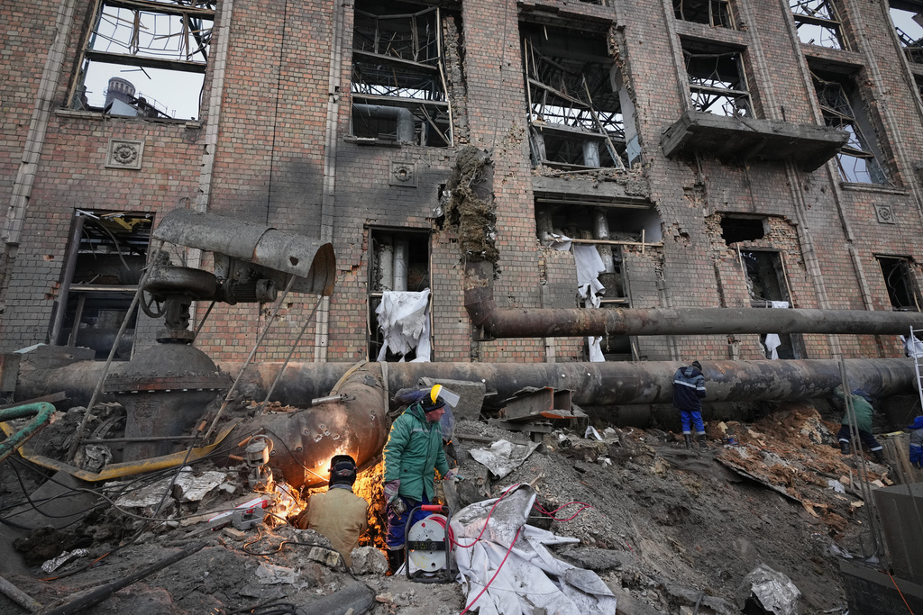 Workers clean up damage at Darnytsia Thermal Power Plant after a Russian attack in Kyiv, Ukraine, Wednesday, Feb. 4, 2026. (AP Photo/Sergei Grits)