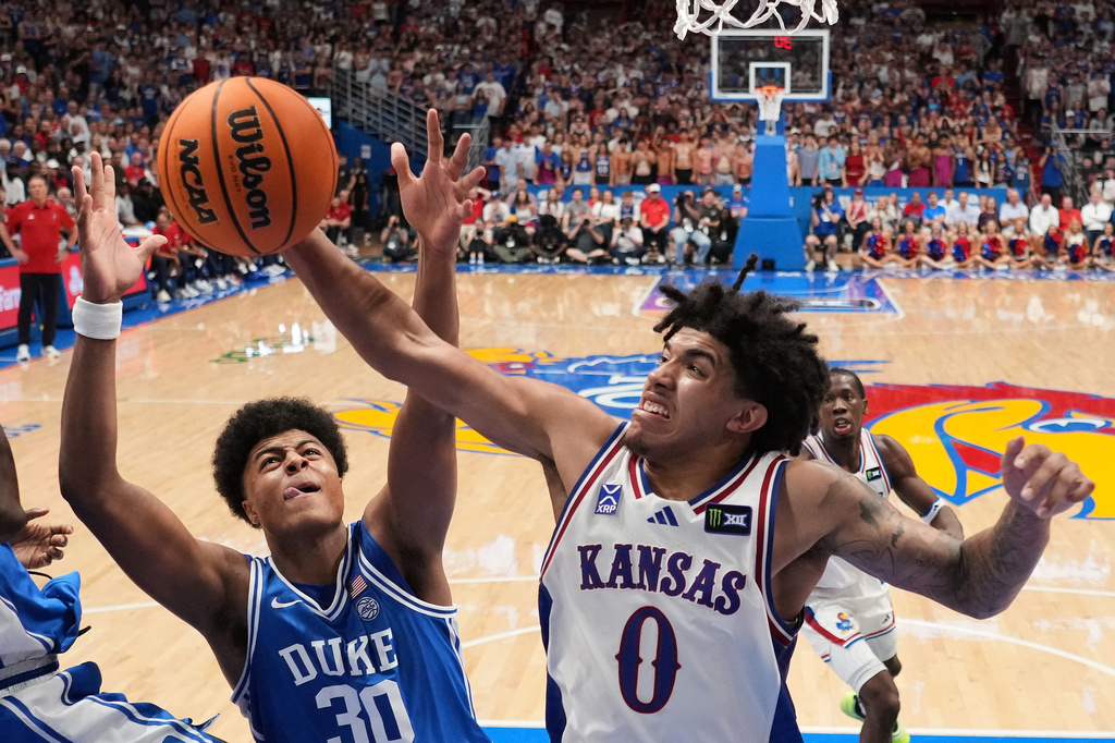 Kansas' Taylen Kinney (0) beats Duke's Joaquim Boumtje Boumtje (30) to a rebound during the second half of an exhibition NCAA college basketball game Sunday, Oct. 25, 2026, in Lawrence, Kan. (AP Photo/Charlie Riedel)