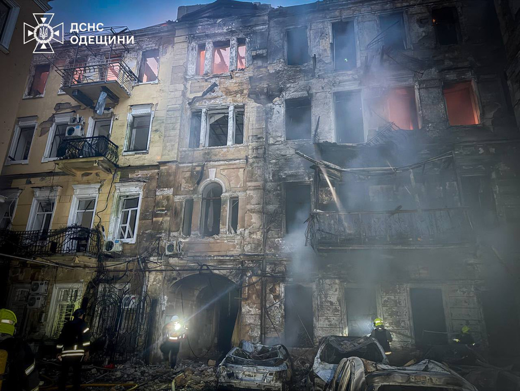 In this photo provided by the Ukrainian Emergency Service, emergency services personnel work to extinguish a fire of residential buildings following a Russian missiles attack in Odesa, Ukraine, Sunday, Aug. 9, 2026. (Ukrainian Emergency Service via AP)