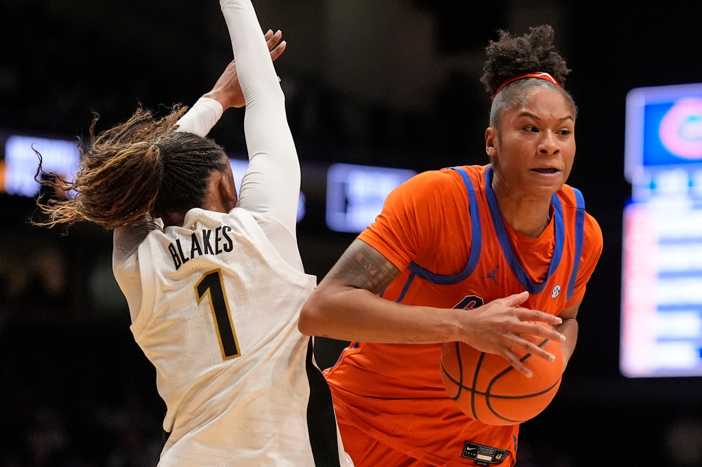 Florida guard Laila Reynolds, right, charges into Vanderbilt guard Mikayla Blakes (1) during the first half of an NCAA college basketball game Sunday, Feb. 1, 2026, in Nashville, Tenn. (AP Photo/George Walker IV)