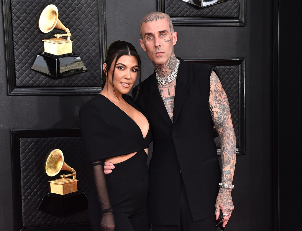 FILE - Kourtney Kardashian, left, and Travis Barker appear at the 64th Annual Grammy Awards in Las Vegas on April 3, 2022. (Photo by Jordan Strauss/Invision/AP, File)