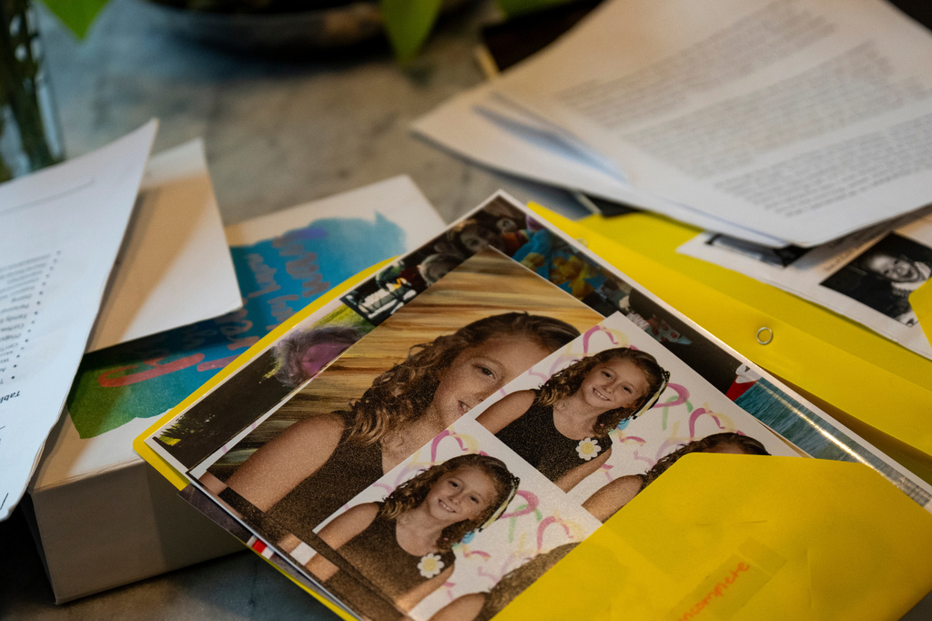 Kate goes through folders of writings and photographs from her time at Unita Academy and other residential programs in her apartment in Kentucky, Wednesday, Dec. 10, 2025. (AP Photo/Michael Swensen)