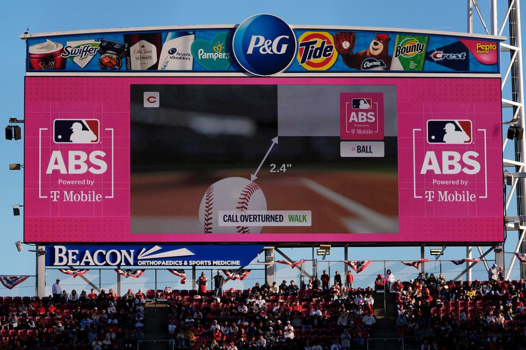 A call is overturned to a walk by the Automated Ball-Strike (ABS) Challenge System, displayed on the stadium screens, after Cincinnati Reds' Will Benson challenged at pitch result during the seventh inning of a baseball game against the Boston Red Sox in Cincinnati, Saturday, March 28, 2026. (AP Photo/Carolyn Kaster)
