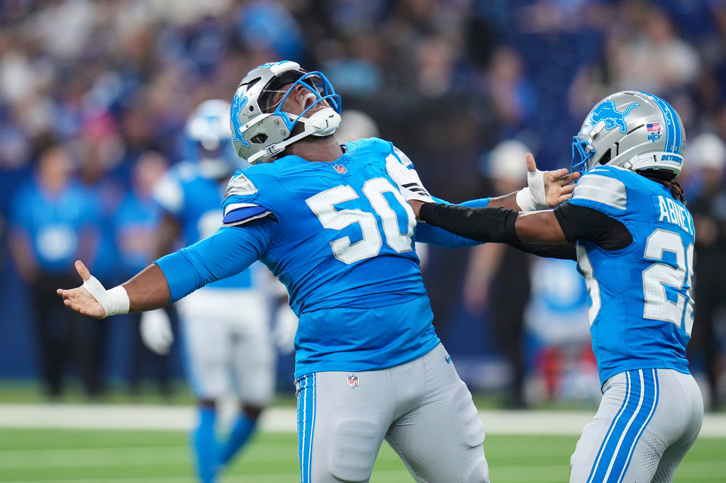 Detroit Lions defensive lineman Skyler Gill-Howard (50) celebrates a sack with cornerback Keith Abney II (28) during the first half of a preseason NFL football game against the Indianapolis Colts in Indianapolis, Saturday, Aug. 29, 2026. (AP Photo/Jeff Roberson)