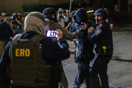 A protester is arrested by police and federal officers outside a U.S. Immigration and Customs Enforcement facility in Portland, Ore., Monday, Oct. 6, 2025. (AP Photo/Ethan Swope) A protester is arrested by police and federal officers outside a U.S. Immigration and Customs Enforcement facility in Portland, Ore., Monday, Oct. 6, 2025. (AP Photo/Ethan Swope)