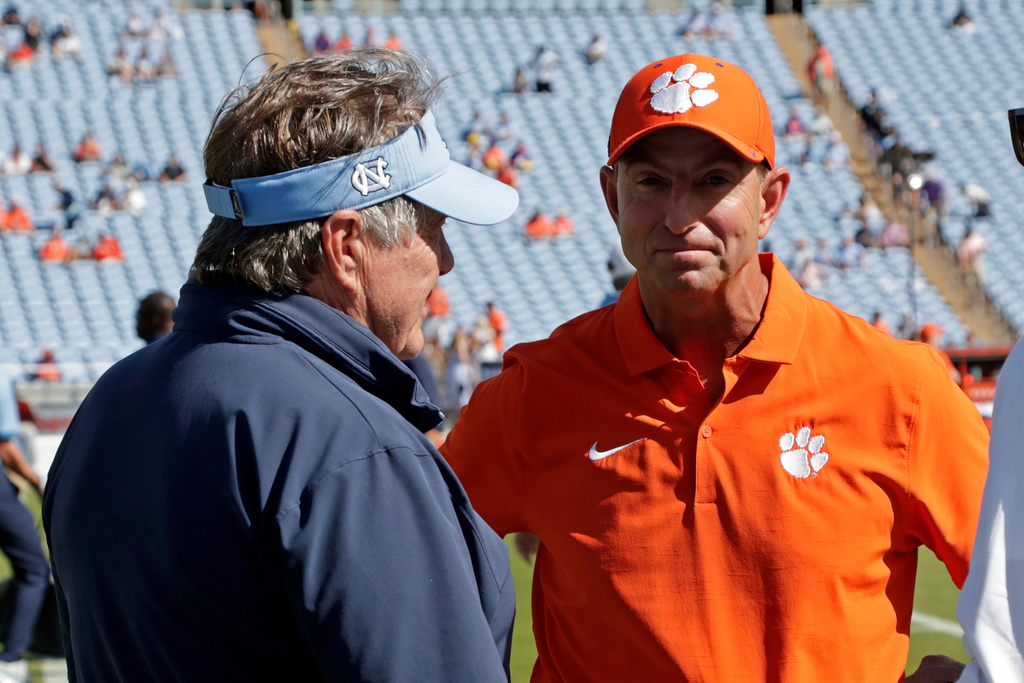 North Carolina head coach Bill Belichick, left, and Clemson head coach Dabo Swinney, right, before an NCAA college football game Saturday, Oct. 4, 2025, in Chapel Hill, N.C. (AP Photo/Chris Seward)