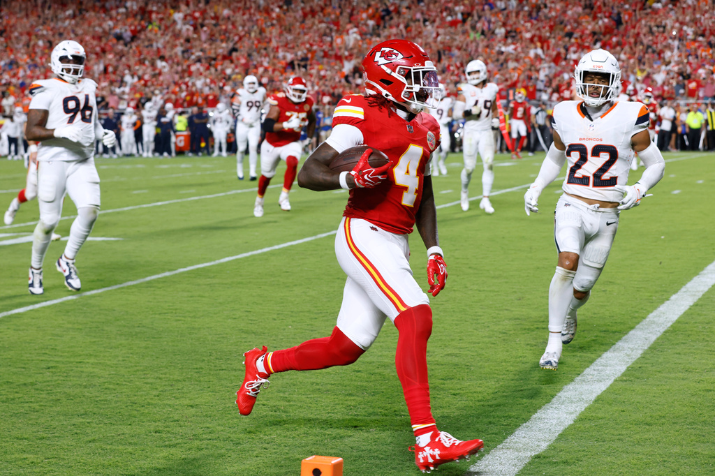 Kansas City Chiefs wide receiver Rashee Rice (4) scores a touchdown in front of Denver Broncos safety Brandon Jones (22) during the first half of an NFL football game Monday, Sept. 14, 2026, in Kansas City, Mo. (AP Photo/Colin E. Braley)