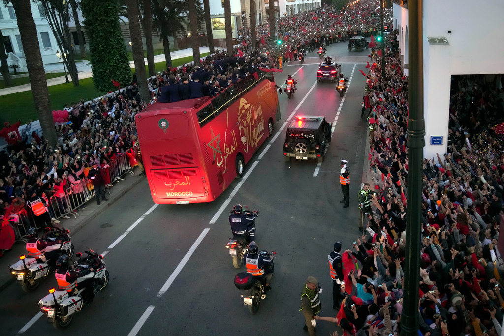 FILE - The players of Morocco national soccer team celebrate on a bus and wave to the public during a homecoming parade in central Rabat, Morocco, Tuesday, Dec. 20, 2022. Morocco national team won the fourth place at the last World Cup. (AP Photo/Mosa'ab Elshamy, File)