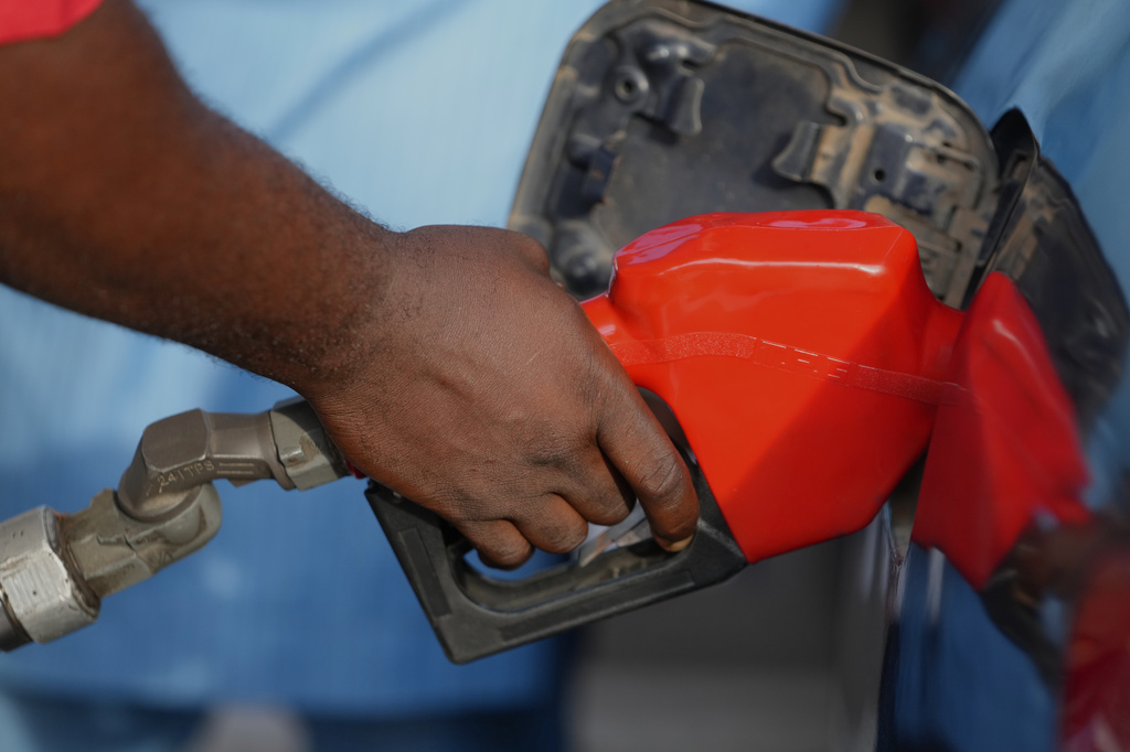 FILE - A service employee is filling a car with fuel at a petrol station in Lagos, Nigeria, March 23, 2026. (AP Photo/Sunday Alamba, File)