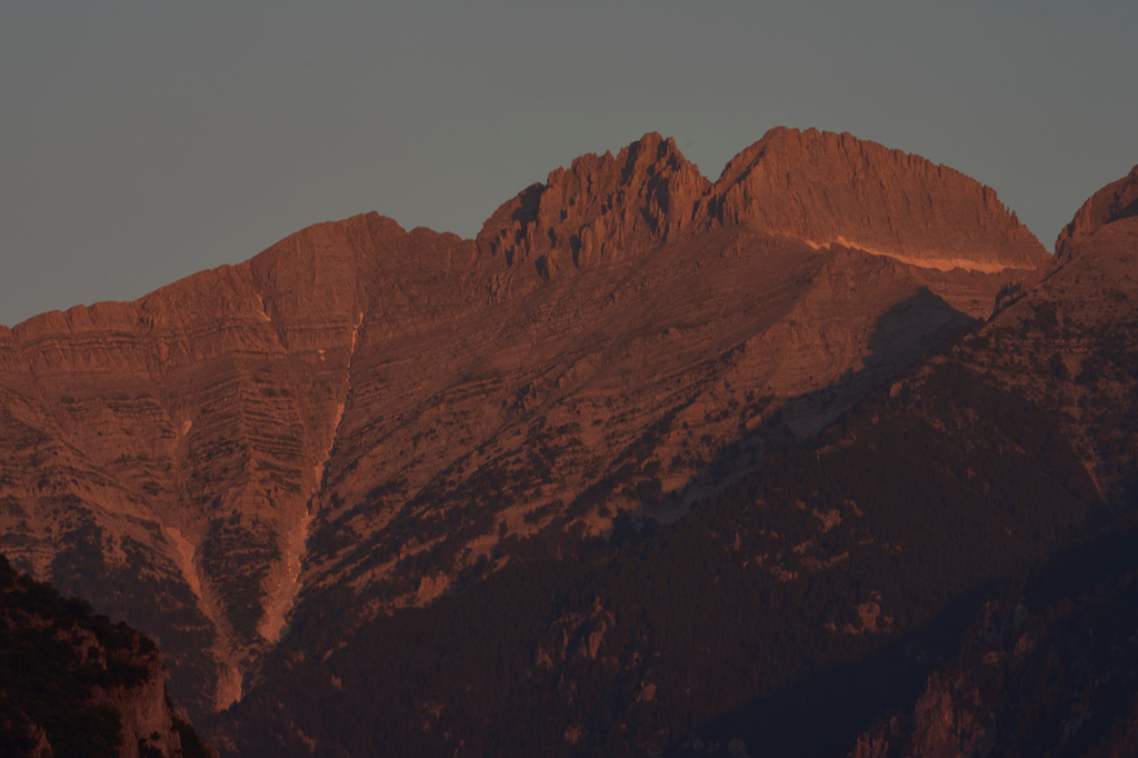 The morning light shines on Mytikas, Greece's highest peak, center left, and Stefani, known as the Throne of Zeus, center right, atop Mount Olympus seen from the outskirts of Litochoro in northern Greece, Wednesday, July 15, 2026. (AP Photo/Petros Giannakouris)