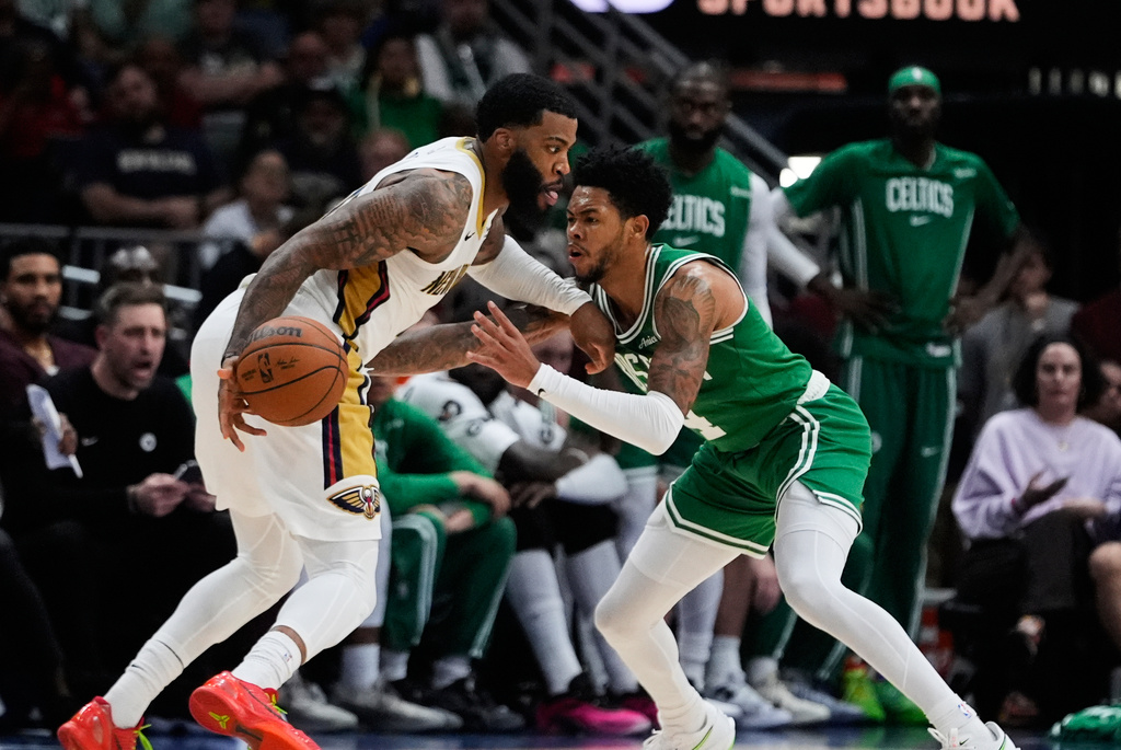New Orleans Pelicans guard Saddiq Bey (41) drives to the basket against Boston Celtics guard Anfernee Simons (4) in the second half of an NBA basketball game, Monday, Oct. 27, 2025, in New Orleans. (AP Photo/Gerald Herbert)
