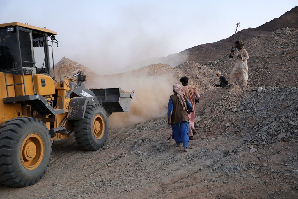 A front-loader loads dirt and crushed rock into a processing machine used to separate gold-bearing material at an artisanal mining site in Dalago Mahas, Sudan's Northern State, Thursday, May 7, 2026. (AP Photo/Mohaned Bilal)