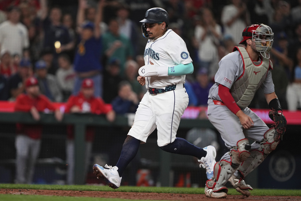 Seattle Mariners' Josh Naylor scores past St. Louis Cardinals catcher Jimmy Crooks on a sacrifice fly from Mariners' Jorge Polanco during the sixth inning of a baseball game Monday, Sept. 8, 2025, in Seattle. (AP Photo/Lindsey Wasson)
