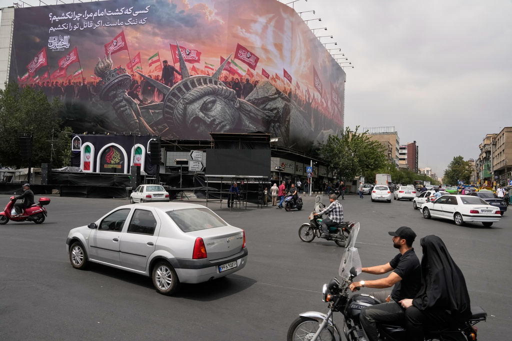 A billboard depicting a fallen Statue of Liberty and crowds carrying Iranian and Shiite flags overlooks Revolution Square in Tehran, Iran, Monday, Aug. 3, 2026. (AP Photo/Vahid Salemi)