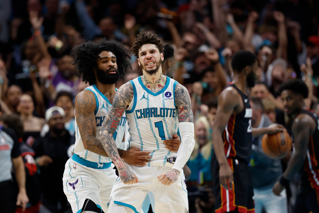 Charlotte Hornets guard LaMelo Ball (1) celebrates with guard Coby White after scoring against the Miami Heat during the second half of an NBA play-in tournament basketball game in Charlotte, N.C., Tuesday, April 14, 2026. (AP Photo/Nell Redmond)