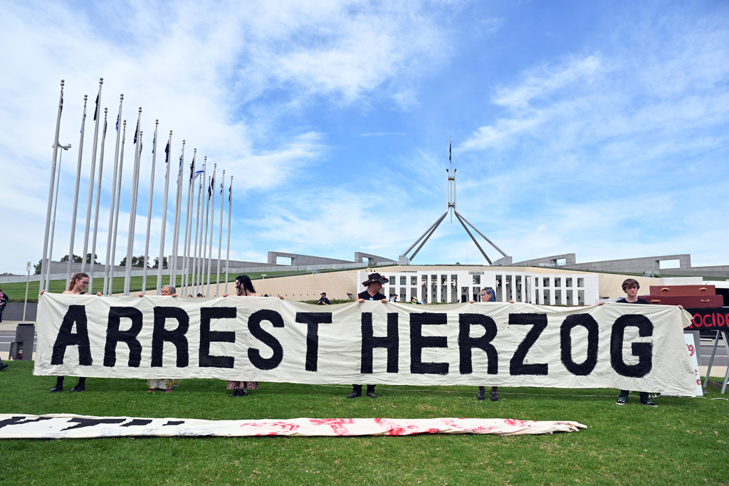 Demonstrators rally at Parliament House in Canberra, Australia, Wednesday, Feb. 11, 2026, to protest the visit by Israeli President Isaac Herzog. (Mick Tsikas/AAP Image via AP)